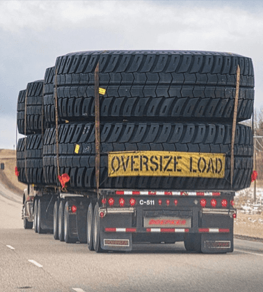 A large truck with tires on the back of it.